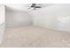 Large bedroom with neutral carpet and a ceiling fan, offering ample open space at 14812 Stonegreen Ln, Huntersville, NC 28078