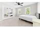 Sunlit bedroom featuring mirrored closet doors, neutral carpet, and two bright windows at 14812 Stonegreen Ln, Huntersville, NC 28078