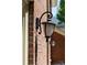 Close-up of brick exterior showcasing an ornate outdoor wall lantern at 14812 Stonegreen Ln, Huntersville, NC 28078