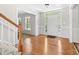Bright foyer with hardwood floors, staircase, and a welcoming front door with transom window at 14812 Stonegreen Ln, Huntersville, NC 28078