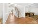 Bright foyer featuring hardwood floors, a staircase, and views into the dining and game rooms at 14812 Stonegreen Ln, Huntersville, NC 28078