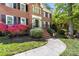 Inviting front entrance with brick steps, wrought iron railings, and colorful flowers adding charm at 14812 Stonegreen Ln, Huntersville, NC 28078