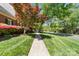 Sidewalk view showcasing a well-maintained lawn and colorful landscaping leading to a lovely home at 14812 Stonegreen Ln, Huntersville, NC 28078