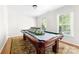 Inviting game room with a classic billiard table and natural light streaming through the windows at 14812 Stonegreen Ln, Huntersville, NC 28078