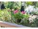A beautiful hanging basket with bright pink flowers adds charm to the outdoor area at 14812 Stonegreen Ln, Huntersville, NC 28078