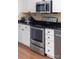 Close-up of a kitchen with stainless steel oven, microwave, and white cabinets with sleek hardware at 14812 Stonegreen Ln, Huntersville, NC 28078