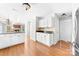 Bright kitchen featuring wood floors, white cabinets, black granite countertops, and stainless steel appliances at 14812 Stonegreen Ln, Huntersville, NC 28078