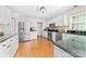 Bright kitchen featuring an island, stainless appliances, and wood floors at 14812 Stonegreen Ln, Huntersville, NC 28078