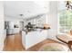 Bright kitchen featuring a center island, stainless appliances, and wood floors at 14812 Stonegreen Ln, Huntersville, NC 28078