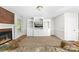 Cozy living room featuring a brick fireplace and built-in shelving at 14812 Stonegreen Ln, Huntersville, NC 28078