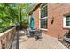 Inviting outdoor deck with an umbrella-covered table, perfect for entertaining alongside the brick house at 14812 Stonegreen Ln, Huntersville, NC 28078