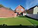 This backyard with putting green, white fence and hot tub is ideal for leisure and entertainment at 1508 Peaceful Way Dr, Charlotte, NC 28206