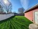A beautiful backyard with synthetic grass and a white fence offers a private outdoor space at 1508 Peaceful Way Dr, Charlotte, NC 28206