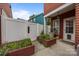 Backyard patio area with landscaping and a white fence at 1508 Peaceful Way Dr, Charlotte, NC 28206