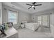 Bright bedroom with tray ceilings, a ceiling fan, and private patio access at 1508 Peaceful Way Dr, Charlotte, NC 28206