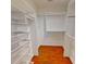Organized walk-in closet with metal basket shelving, a hanging rod, and hardwood floors at 1508 Peaceful Way Dr, Charlotte, NC 28206