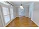Bright dining room showcasing wood floors, neutral walls, and a view towards the entryway at 1508 Peaceful Way Dr, Charlotte, NC 28206