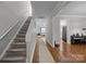 Inviting home hallway with hardwood floors and staircase leading to upper level at 1508 Peaceful Way Dr, Charlotte, NC 28206