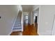 Bright foyer with wood floors, a staircase, and neutral paint, leading into the living spaces at 1508 Peaceful Way Dr, Charlotte, NC 28206