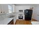 Modern kitchen featuring white cabinets, quartz counters, stainless steel appliances and wooden floors at 1508 Peaceful Way Dr, Charlotte, NC 28206