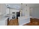 Modern kitchen featuring white cabinets, marble countertops, stainless steel appliances, and a large island at 1508 Peaceful Way Dr, Charlotte, NC 28206