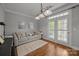Bright living room featuring a comfortable sofa and French doors at 1508 Peaceful Way Dr, Charlotte, NC 28206