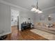 Cozy living room with plush sofa, piano, and stylish chandelier at 1508 Peaceful Way Dr, Charlotte, NC 28206