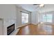 Comfortable living room featuring a cozy fireplace and bright windows with natural light at 1508 Peaceful Way Dr, Charlotte, NC 28206