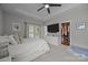 Spacious primary bedroom with a closet, tray ceilings, and access to a private outdoor patio at 1508 Peaceful Way Dr, Charlotte, NC 28206