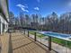 Enjoy the view from the deck overlooking the modern pool, well-manicured lawn, and tree-filled surroundings at 1525 Shinnville Rd, Cleveland, NC 27013