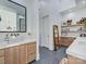 Bright bathroom with double vanity, wooden cabinets, decorative shelves, and a modern design at 1525 Shinnville Rd, Cleveland, NC 27013