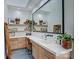 Modern bathroom features a large mirror, floating shelves, and wood cabinets with a clean countertop design at 1525 Shinnville Rd, Cleveland, NC 27013