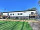 Modern two-story house showcasing brick and white siding with two attached decks, and an artificial lawn at 1525 Shinnville Rd, Cleveland, NC 27013