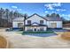 Stunning modern farmhouse with black trim, glass doors, covered porch, and manicured lawn on a sunny day at 1525 Shinnville Rd, Cleveland, NC 27013