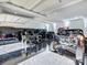 Organized garage featuring sleek black storage cabinets, epoxy floors and room for multiple off-road vehicles at 1525 Shinnville Rd, Cleveland, NC 27013