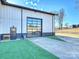 Exterior garage view showcasing its modern design, glass panel door, side door, and artificial lawn at 1525 Shinnville Rd, Cleveland, NC 27013