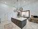 Bright, modern kitchen with large island and view into an adjoining room at 1525 Shinnville Rd, Cleveland, NC 27013