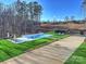 Beautiful pool area with modern landscaping, a concrete pool, and outdoor seating, surrounded by trees at 1525 Shinnville Rd, Cleveland, NC 27013