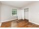 Hardwood-floored bedroom with neutral walls, a window, and closet at 1532 Downs Ave, Charlotte, NC 28205