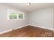 Bright bedroom with hardwood floors, a window, and neutral-colored walls at 1532 Downs Ave, Charlotte, NC 28205