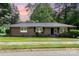Brick home with black shutters, green lawn, and sidewalk leading to the front door at 1532 Downs Ave, Charlotte, NC 28205