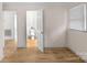 Bright room with wooden floors, open door to white bathroom at 1607 Old Lawyers Rd, Marshville, NC 28103