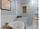 Elegant bathroom with a freestanding tub, wainscoting, and stylish fixtures at 1607 Old Lawyers Rd, Marshville, NC 28103