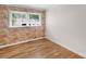 Bright bedroom with wooden floors and wallpapered accent wall at 1607 Old Lawyers Rd, Marshville, NC 28103