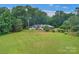 Sprawling ranch home on a large lot surrounded by mature trees and a wooden fence for added charm at 1607 Old Lawyers Rd, Marshville, NC 28103