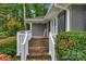 Home's front porch with mature landscaping and a painted brick exterior at 1607 Old Lawyers Rd, Marshville, NC 28103