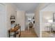 Well-lit hallway with hardwood floors, console table, and glimpses into the living room and dining area at 1607 Old Lawyers Rd, Marshville, NC 28103