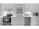 Modern kitchen featuring stainless steel appliances, white cabinets, and a view from the window at 1607 Old Lawyers Rd, Marshville, NC 28103