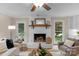 Charming living room features a brick fireplace, hardwood floors, and natural light from the window at 1607 Old Lawyers Rd, Marshville, NC 28103