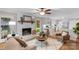 Cozy living area with a brick fireplace, hardwood floors, comfortable seating, and a view into the kitchen at 1607 Old Lawyers Rd, Marshville, NC 28103